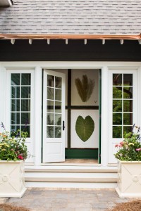 Beautiful French doors open to the courtyard and the hallway's large pressed botanicals bring the outdoors inside.     