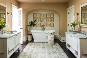 The master bathroom is designed to highlight the freestanding tub underneath the archway. Lauren Liess's natural interior design creates a serene setting.          