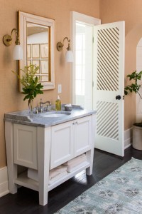 His and hers marble vanities and custom made doors add symmetry to the master bath.           