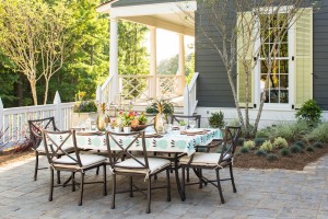The dining terrace, designed by Margaret Kirkland Interiors, is highlighted by native landscape and hardscape done by David N. Brush, Landscape Architect.     