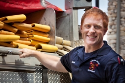 A fireman from the Mt Laurel Fire Department gathers hose pipe for a presentation at Mt Laurel Elementary School.    