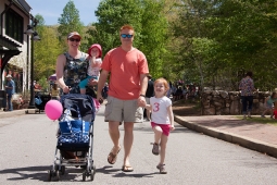 Families leisurely explore the business district during the Mt Laurel Spring Festival.  