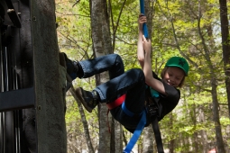 A young resident scales a rock-climbing wall in Mt Laurel's town center. 