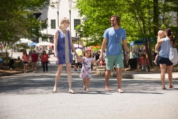 A family soaks up the sun in Mt Laurel's town center during the annual Spring Festival.  