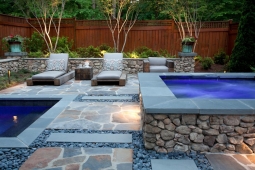 Beautifully designed, this backyard features several stone accents.    