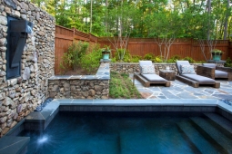 A pump recycles water into a backyard dipping pool.         