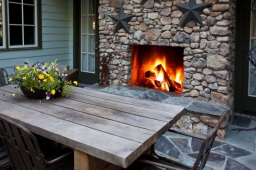 This outdoor patio features a stonework fireplace—perfect for entertaining guests on mild days.             