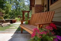 A cedar bench provides the perfect place for residents to hang out in their backyard.             