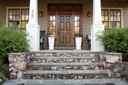 White columns, intricate stonework, and dark wood-framed windows welcome visitors to this Mt Laurel home.             