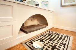 Custom built-in dog bed offers an organized place for the four-legged members of the family.                        
