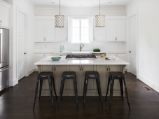 Light and bright kitchen with large island and shiplap walls.   Photo: Tommy Daspit               