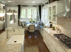 Granite counters, custom white cabinetry, and Kitchenaid appliances make the gourmet kitchen elegant and functional.        