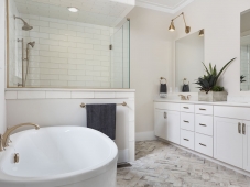 This master bathroom features a freestanding tub, customized cabinetry and beautiful tile. Photo: Tommy Daspit              