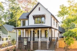 The wraparound front porch welcomes you to the beautiful Redbud Cottage.    