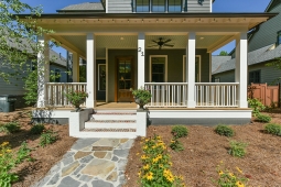 The wide front porch on the Redbud Cottage welcomes guests with charm.             
