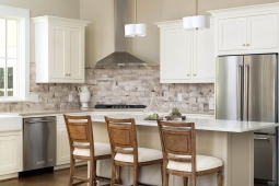 Beautiful kitchen with quartz counters, farmhouse sink, tile backsplash, and Kitchenaid appliances.       